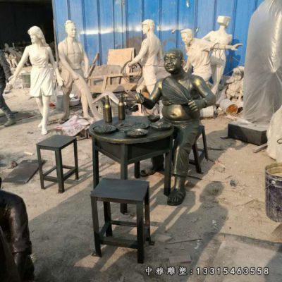 街边铜雕吃饭人物